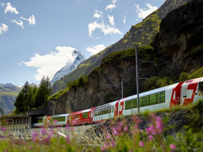 The Glacier Express with Matterhorn in background as part of a fun Swiss Alps paragliding adventure