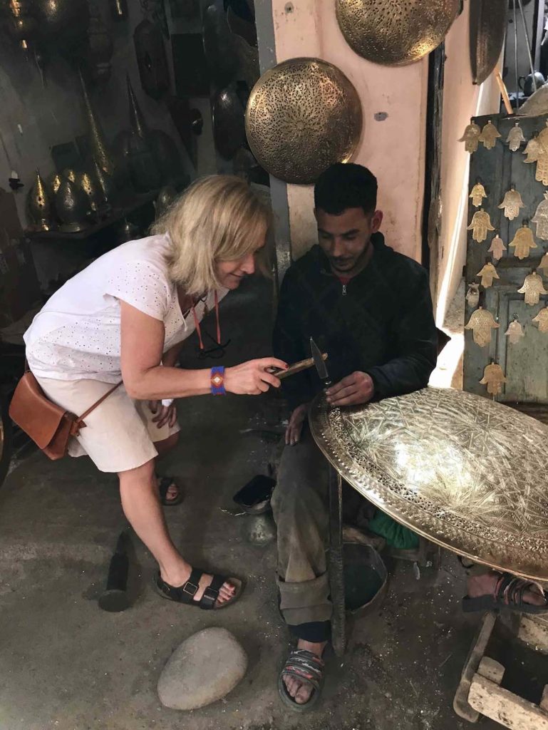 The author tries her hand at metalworking in the Marrakech Medina souks